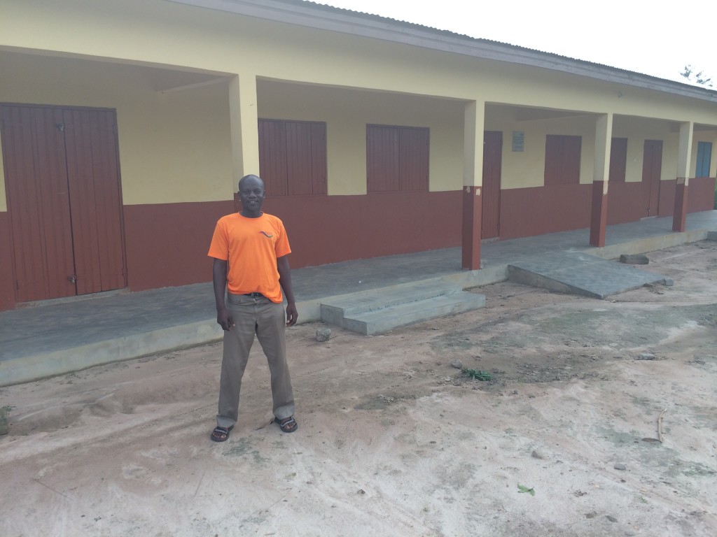 David in front of the school he helped build in his home village. 